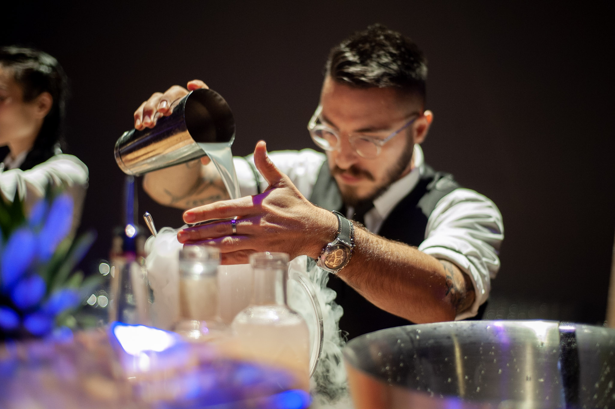 Bartender pouring cocktail from shaker