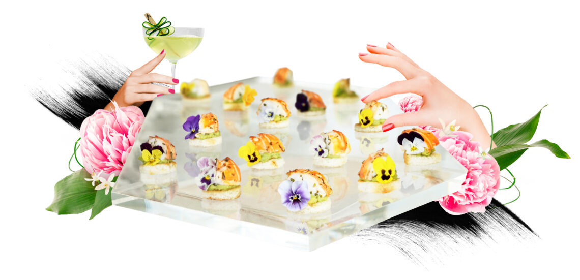Acrylic platter with lobster bites and edible flowers with hands reaching for food