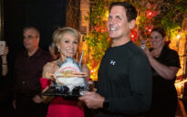 Barbara Corcoran and Mark Cuban with shark-shaped birthday cake