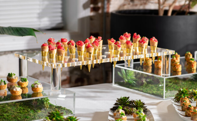 Event food station with acrylic elevation displaying tuna tartare in cones