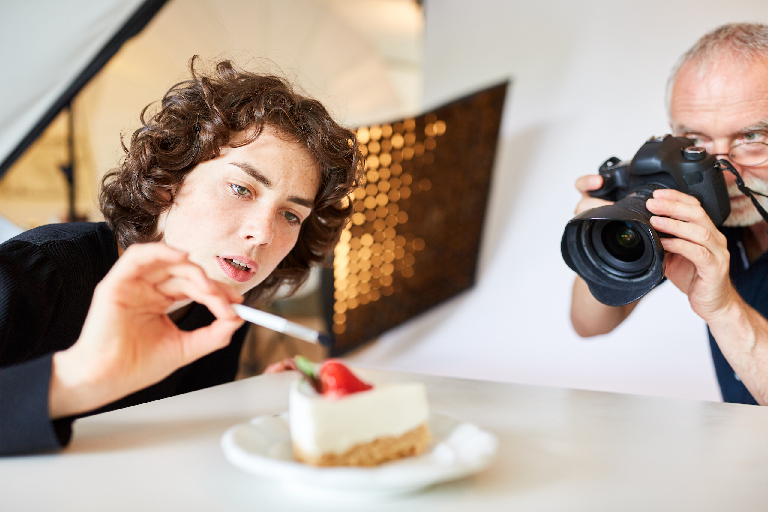Food stylist and photographer with camera