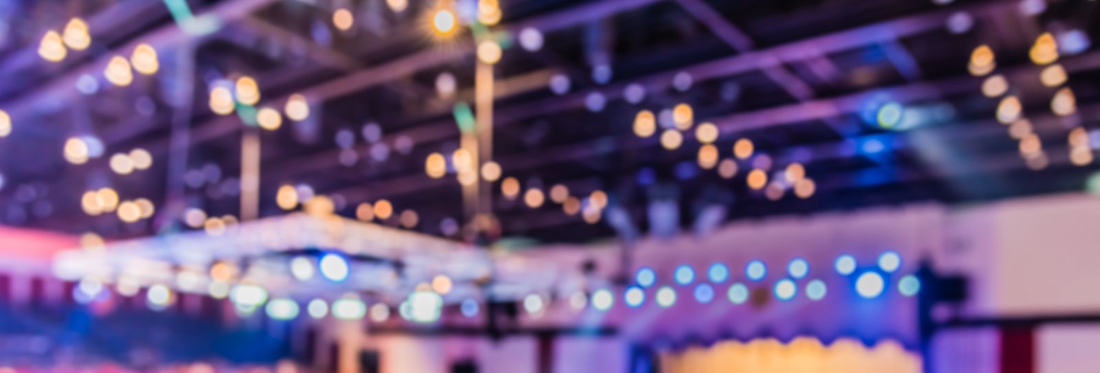 why is the location of an event important: Blurry party venue image.