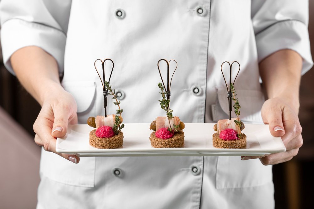 Chef presenting elegant hors d'oeuvres and luxury catering appetizers
